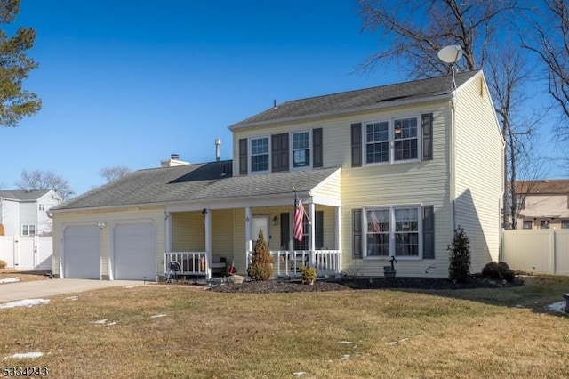 colonial inspired home with a garage, a front yard, and covered porch