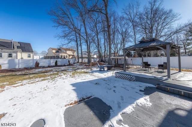 yard covered in snow with a gazebo