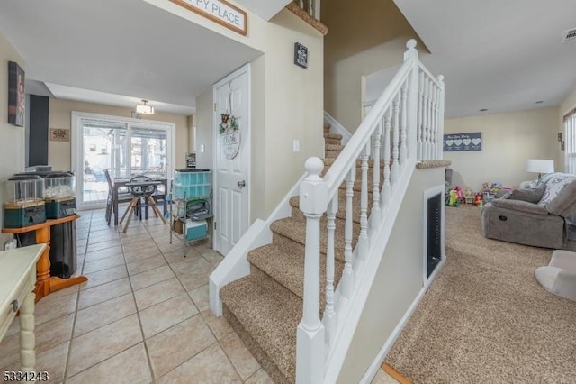 stairway with tile patterned flooring