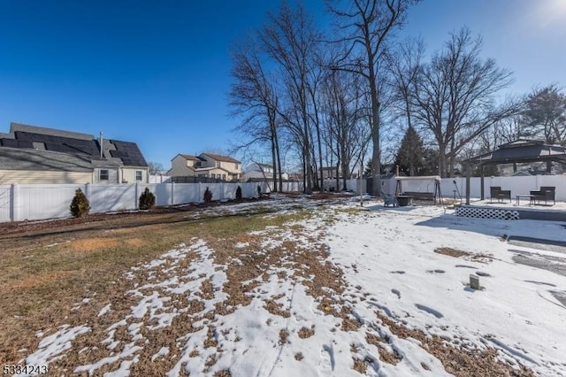 snowy yard featuring a gazebo