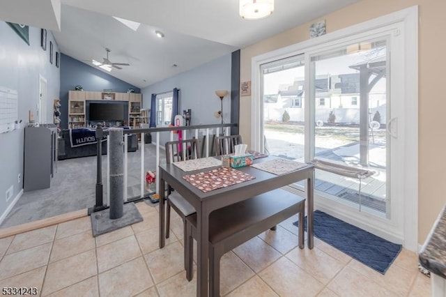 tiled dining space with vaulted ceiling and ceiling fan