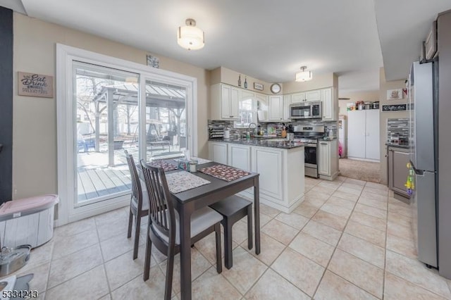 dining room with light tile patterned flooring and sink