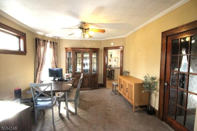 carpeted dining room featuring crown molding, ceiling fan, and french doors