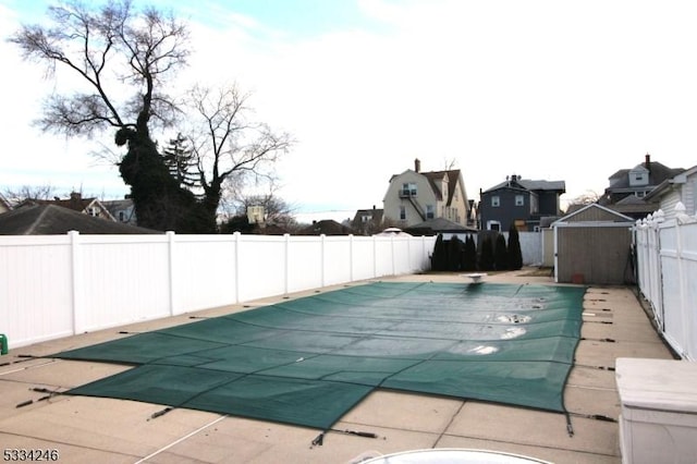 view of swimming pool featuring a diving board and a patio area