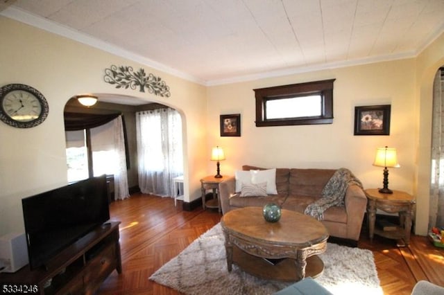 living room with a wealth of natural light, ornamental molding, and dark parquet floors