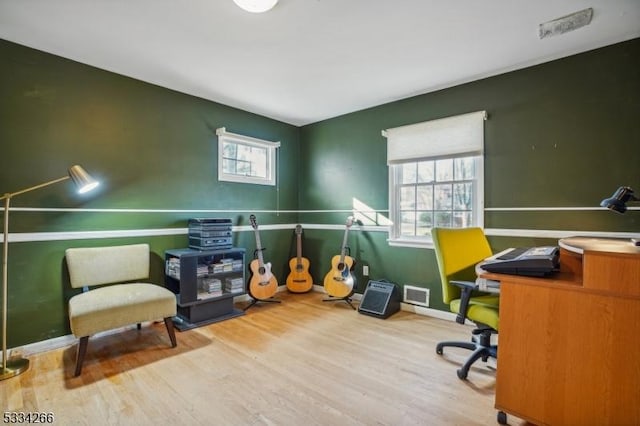 office area with a healthy amount of sunlight and light hardwood / wood-style flooring