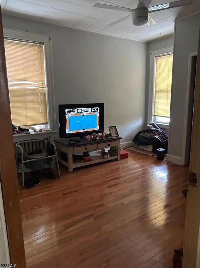 interior space with hardwood / wood-style floors and ceiling fan