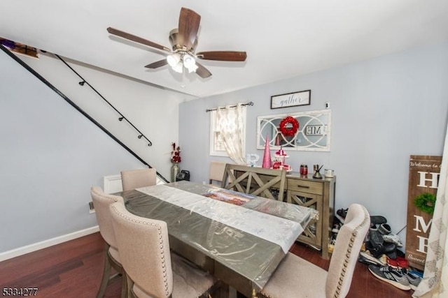 dining area featuring dark wood-type flooring and ceiling fan