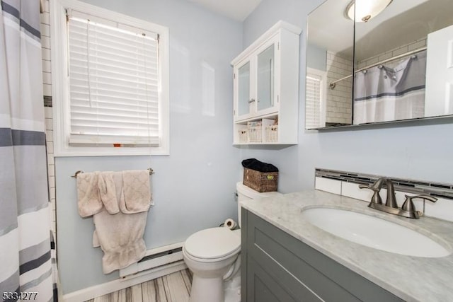 bathroom with vanity, a shower with shower curtain, baseboard heating, and toilet