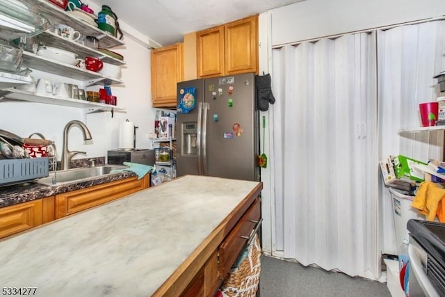 kitchen with stainless steel refrigerator with ice dispenser and sink