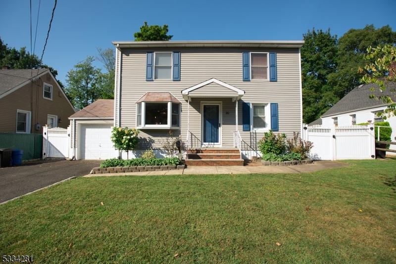 view of front of home with a garage and a front lawn