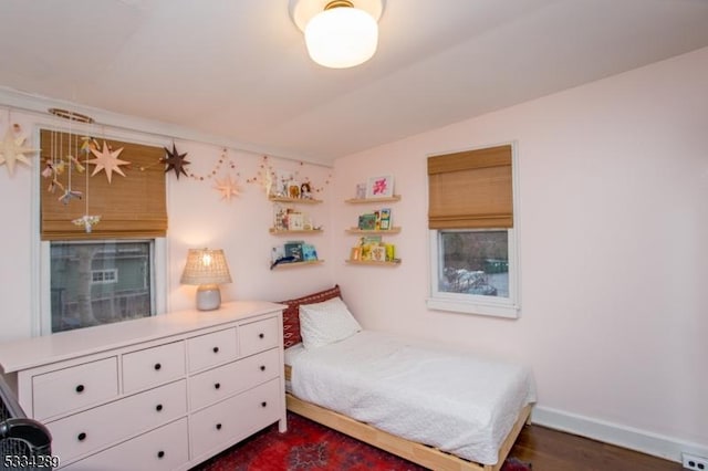 bedroom with dark wood-type flooring