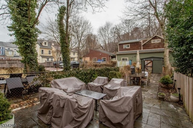 view of patio featuring a storage unit