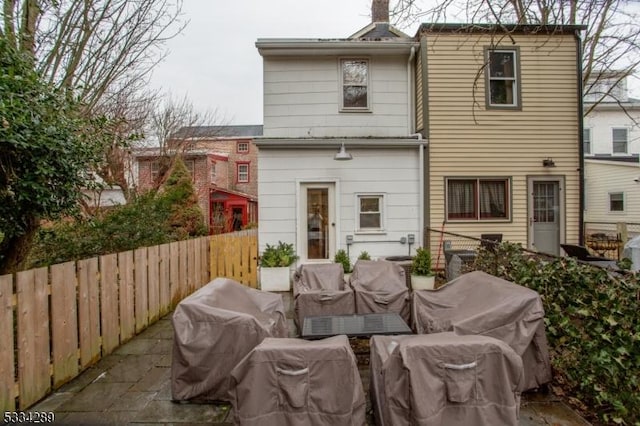 back of property featuring outdoor lounge area and a patio area