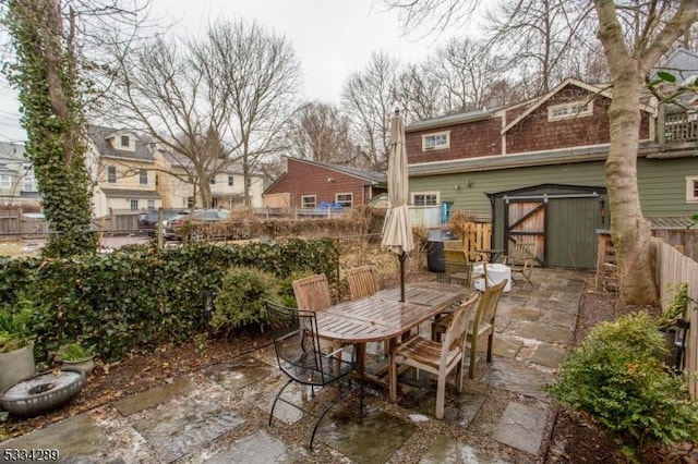 view of patio featuring a storage unit