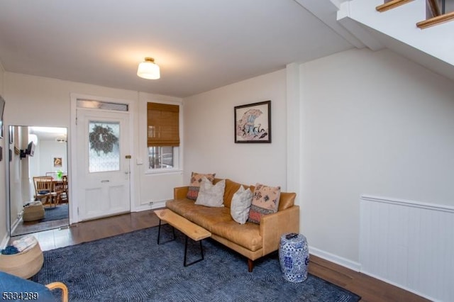 living room featuring vaulted ceiling and dark hardwood / wood-style flooring