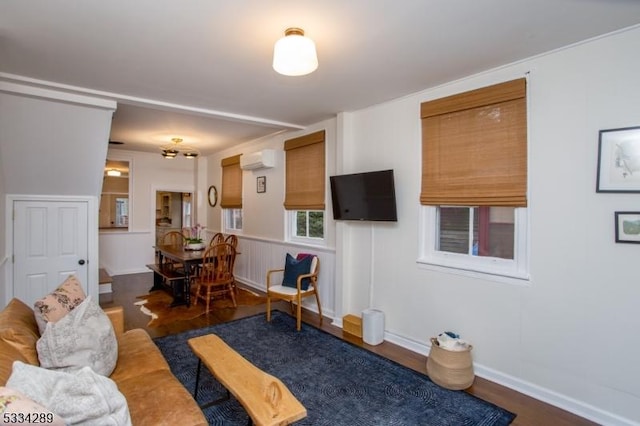 living room with a wall mounted air conditioner and dark hardwood / wood-style flooring