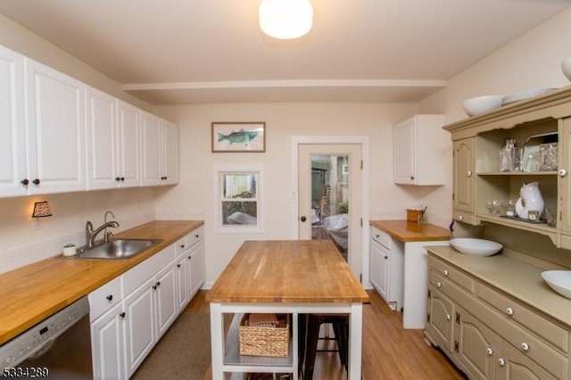 kitchen with sink, light hardwood / wood-style flooring, wooden counters, white cabinetry, and black dishwasher