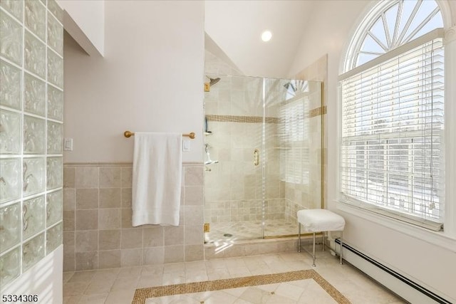 bathroom featuring walk in shower, tile patterned floors, vaulted ceiling, tile walls, and a baseboard heating unit