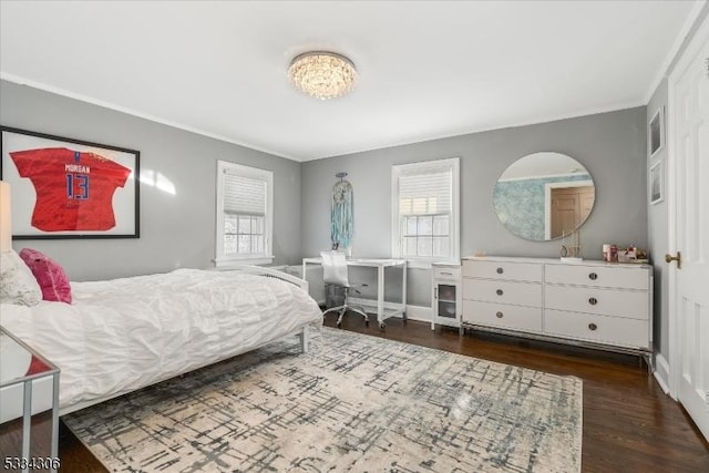 bedroom featuring multiple windows, ornamental molding, and dark hardwood / wood-style floors