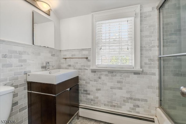 full bathroom featuring vanity, enclosed tub / shower combo, tile walls, and toilet