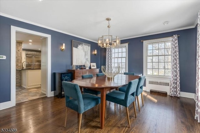 dining room with ornamental molding, radiator heating unit, and dark hardwood / wood-style flooring