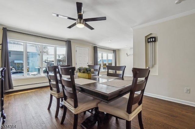 dining space featuring crown molding, plenty of natural light, dark hardwood / wood-style floors, and a baseboard heating unit