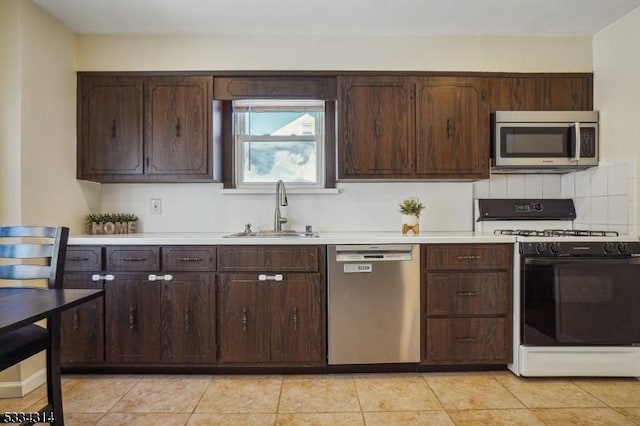 kitchen with stainless steel appliances, dark brown cabinets, and sink