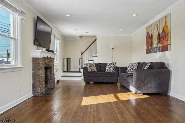 living room featuring crown molding, a fireplace, and dark hardwood / wood-style floors