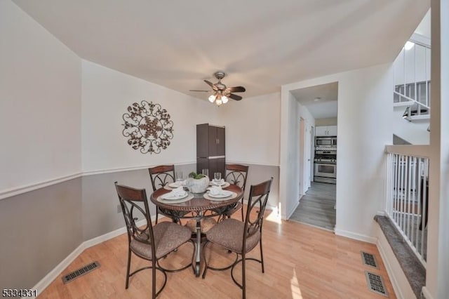 dining room featuring light hardwood / wood-style floors and ceiling fan