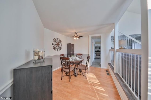 dining room with wood-type flooring and ceiling fan