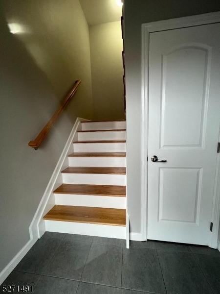 stairs featuring tile patterned flooring