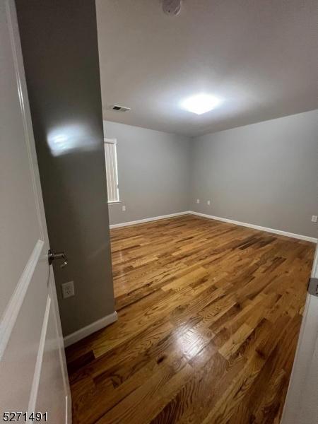 unfurnished room featuring hardwood / wood-style floors