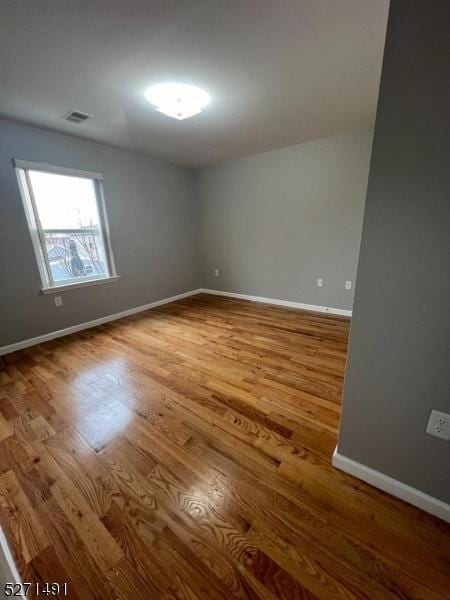 empty room featuring hardwood / wood-style flooring