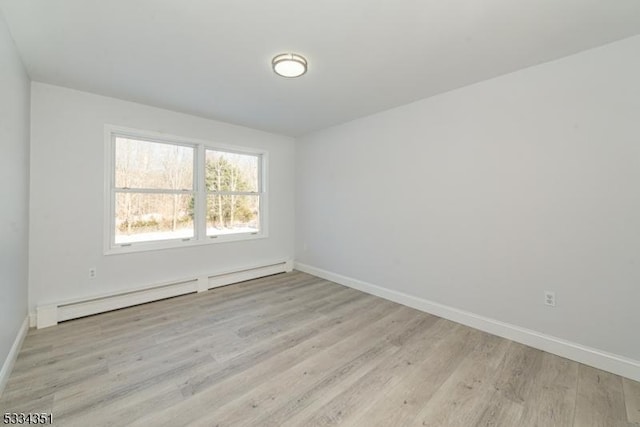 spare room with light hardwood / wood-style floors and a baseboard heating unit