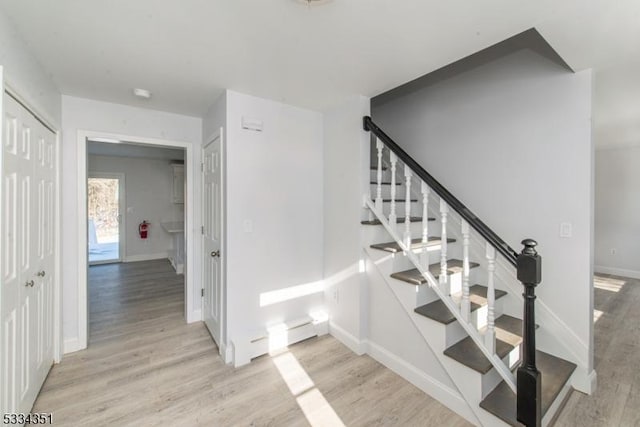 stairs featuring hardwood / wood-style floors