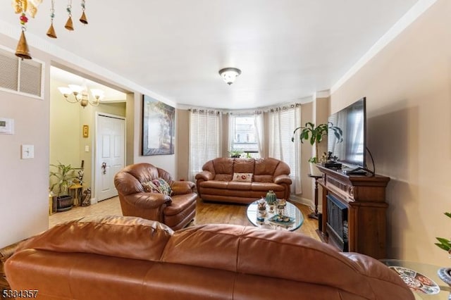 living room featuring an inviting chandelier and light hardwood / wood-style floors