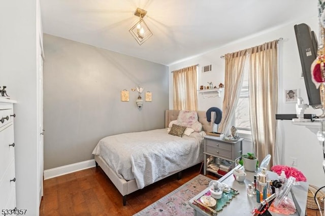 bedroom with dark hardwood / wood-style floors