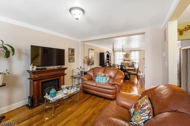 living room featuring hardwood / wood-style flooring and ornamental molding