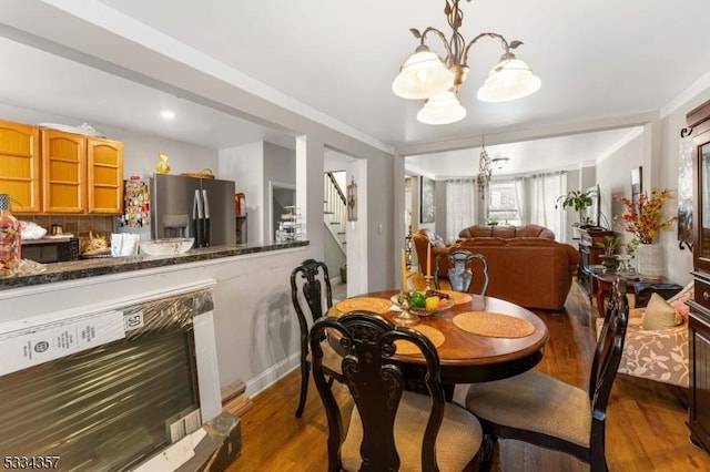 dining area featuring hardwood / wood-style floors and a notable chandelier