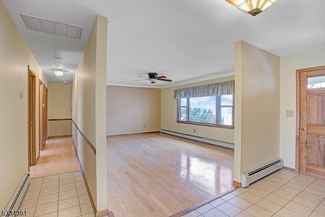 foyer entrance featuring ceiling fan, light tile patterned floors, and baseboard heating