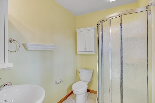 bathroom with an enclosed shower, sink, tile patterned floors, and toilet