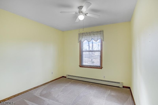 carpeted spare room featuring a baseboard radiator and ceiling fan