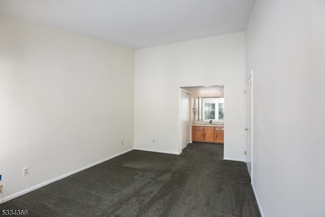 carpeted spare room featuring sink