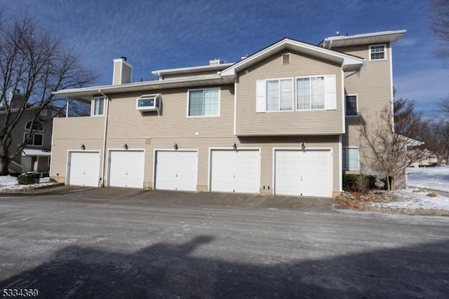 rear view of property featuring a wall unit AC