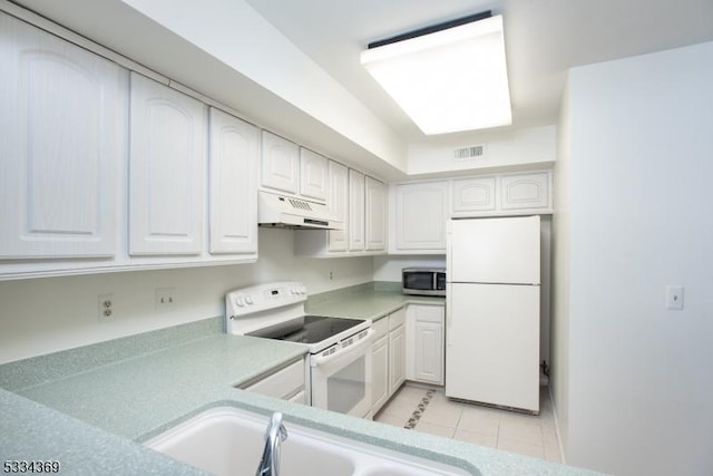 kitchen featuring white cabinetry, sink, light tile patterned floors, and white appliances