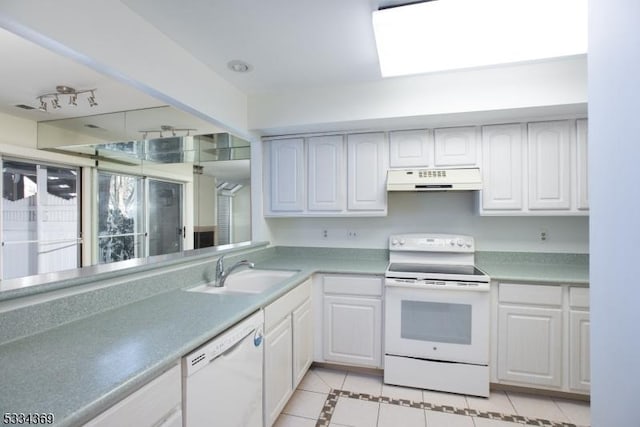 kitchen featuring white cabinetry, sink, and white appliances