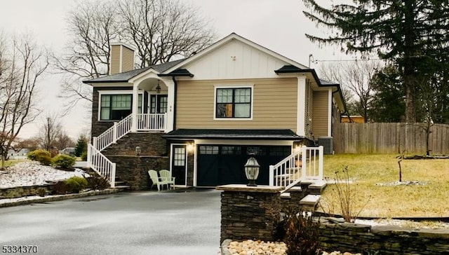 view of front of house featuring a garage and central air condition unit