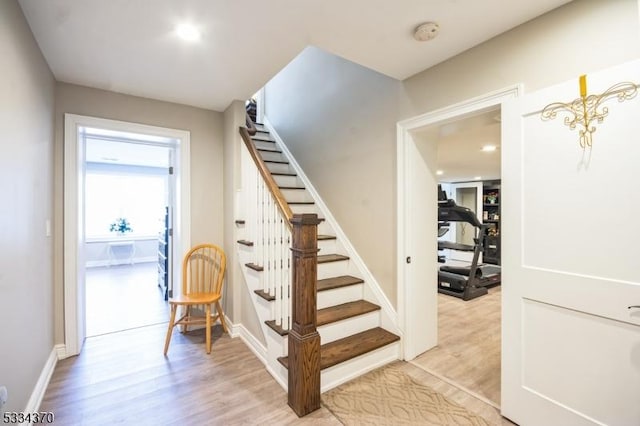 stairs featuring wood-type flooring