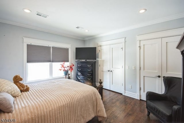 bedroom with dark hardwood / wood-style flooring and ornamental molding